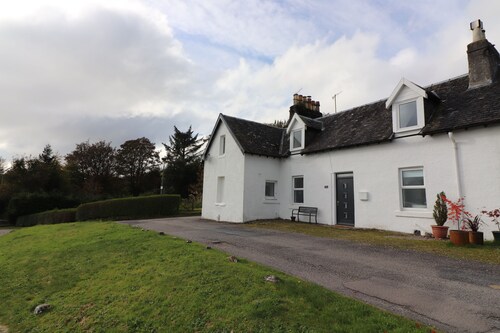 Traditional whitewashed fisherman's cottage overlooking Loch Fyne