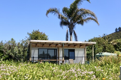 Beachside Cabin with view of Mount Pataua and Surf bar