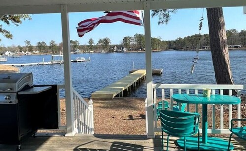 Steps from the water with a private dock, a big relaxing porch & great amenities