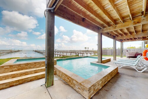 Stunning bay front home with fishing pier, large deck, & private pool