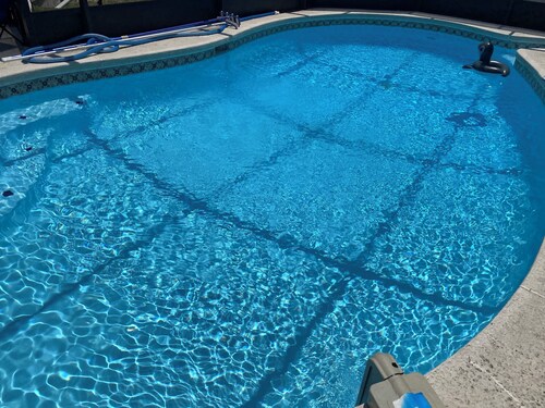 3-bedroom house in Jacksonville with fenced backyard and screen enclosed pool.