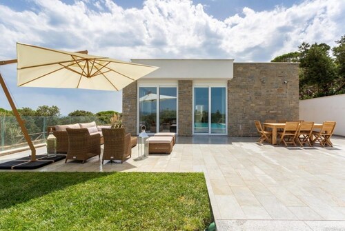Design beachfront villa, private pool, a/c, WiFi, garden and parking space