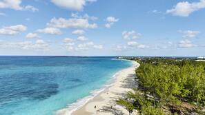 On the beach, white sand, sun-loungers, beach towels