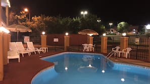 Seasonal outdoor pool, open 10:00 AM to 10:00 PM, pool umbrellas
