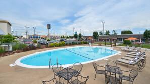 Seasonal outdoor pool, open 10:00 AM to 10:00 PM, pool umbrellas