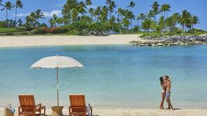On the beach, white sand, beach cabanas, beach umbrellas