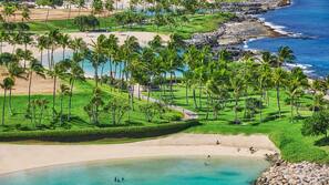 On the beach, white sand, beach cabanas, beach umbrellas