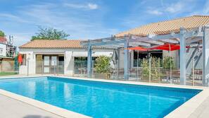 Outdoor pool, open 8 AM to 10 PM, pool umbrellas, pool loungers