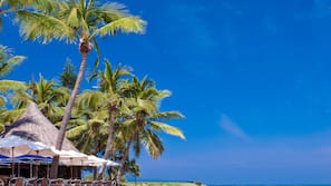 On the beach, sun-loungers, beach umbrellas, beach towels