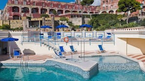 Seasonal outdoor pool, open 10:30 AM to 6:30 PM, pool umbrellas