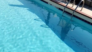 Seasonal outdoor pool, open 9:00 AM to 10:00 PM, pool umbrellas