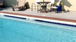 Seasonal outdoor pool, open 9:00 AM to 10:00 PM, pool umbrellas