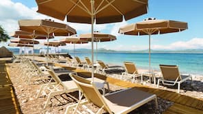 On the beach, sun loungers, beach umbrellas, beach towels