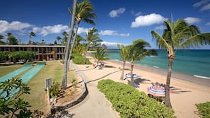 On the beach, white sand, sun loungers, beach umbrellas