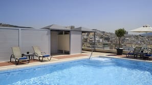 Seasonal outdoor pool, pool umbrellas, pool loungers