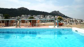Seasonal outdoor pool, pool umbrellas, pool loungers