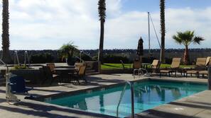 Outdoor pool, open 7 AM to 10 PM, pool umbrellas, pool loungers