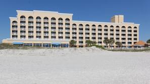 On the beach, white sand, sun loungers, beach umbrellas