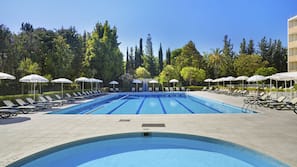 Seasonal outdoor pool, open 10:00 AM to 7:00 PM, pool umbrellas