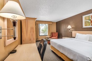 Premium bedding, desk, laptop workspace, blackout drapes