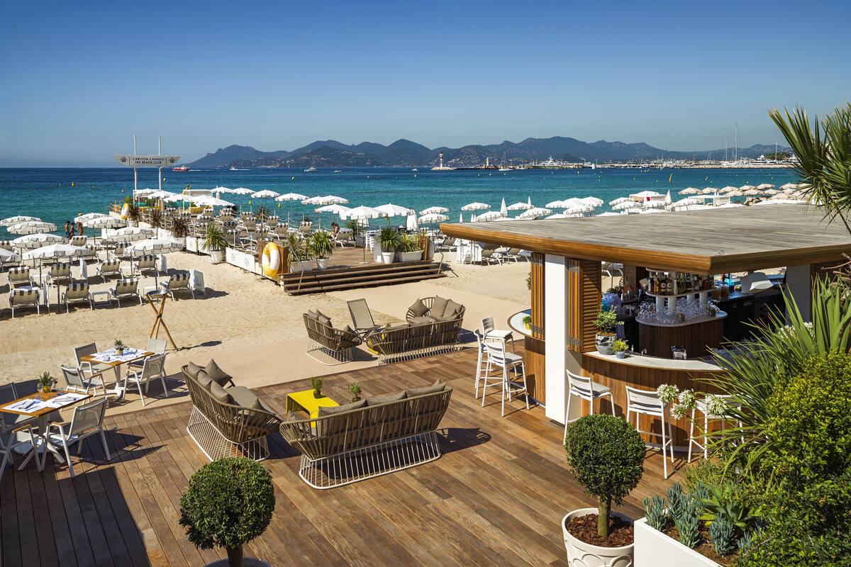On the beach, white sand, sun-loungers, beach umbrellas