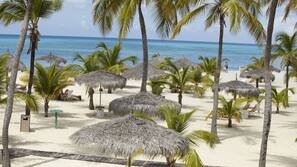 On the beach, white sand, free beach cabanas, sun loungers