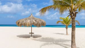 On the beach, white sand, free beach cabanas, sun loungers