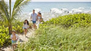 On the beach, white sand, sun loungers, beach umbrellas