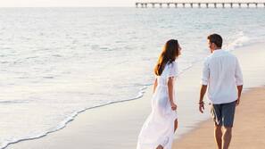 On the beach, white sand, sun loungers, beach umbrellas