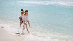 On the beach, white sand, sun loungers, beach umbrellas