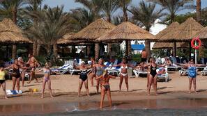 On the beach, sun-loungers, beach umbrellas, beach towels