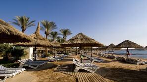 On the beach, sun-loungers, beach umbrellas, beach towels