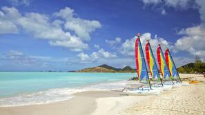 On the beach, white sand, sun-loungers, beach umbrellas