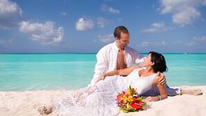 On the beach, white sand, sun-loungers, beach umbrellas