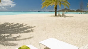 On the beach, white sand, sun-loungers, beach umbrellas