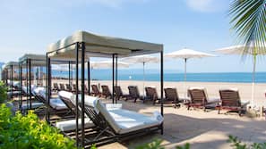 On the beach, sun loungers, beach umbrellas, beach towels