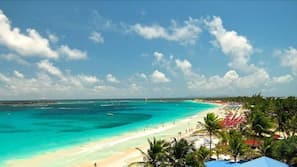 On the beach, white sand, sun loungers, beach umbrellas