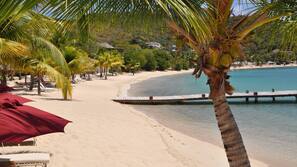 On the beach, white sand, sun-loungers, beach umbrellas