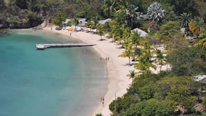 On the beach, white sand, sun-loungers, beach umbrellas