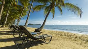 On the beach, sun-loungers, beach towels, beach yoga
