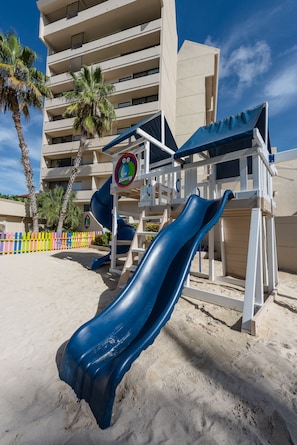 On the beach, white sand, sun loungers, beach umbrellas