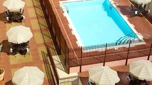 Seasonal outdoor pool, open 9 AM to 7:00 PM, pool umbrellas