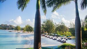 On the beach, white sand, sun loungers, beach umbrellas