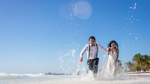 On the beach, white sand, sun-loungers, beach umbrellas