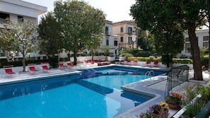 Outdoor pool, open 9:00 AM to 6:00 PM, pool loungers