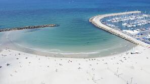 On the beach, sun-loungers