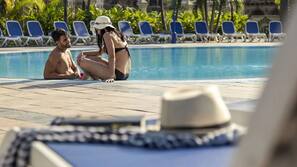 Outdoor pool, open 10 AM to 6 PM, pool umbrellas