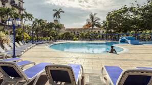 Outdoor pool, open 10 AM to 6 PM, pool umbrellas
