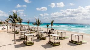 On the beach, white sand, beach towels, beach volleyball