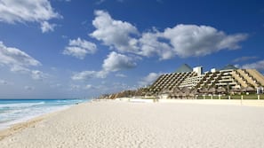 On the beach, white sand, beach towels, beach volleyball